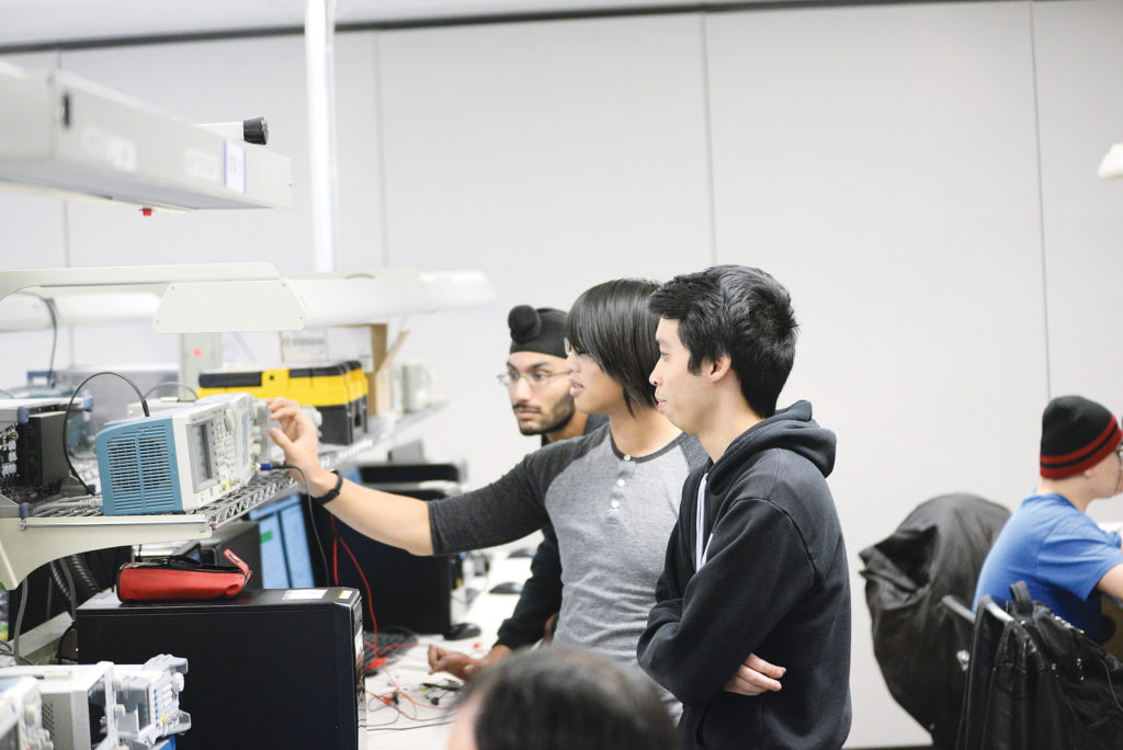Diverse computer engineering students working together.
