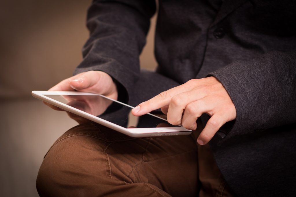 man touching iPad