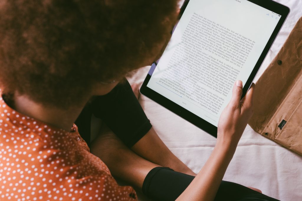 Woman reading on etext ipad.