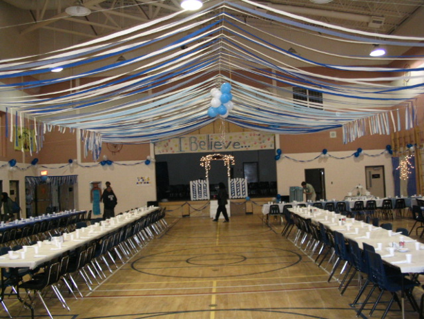 A decorated gym with place settings