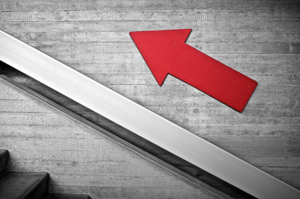 Red arrow pointing upwards.