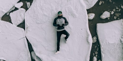 Man lying on his back on broken ice