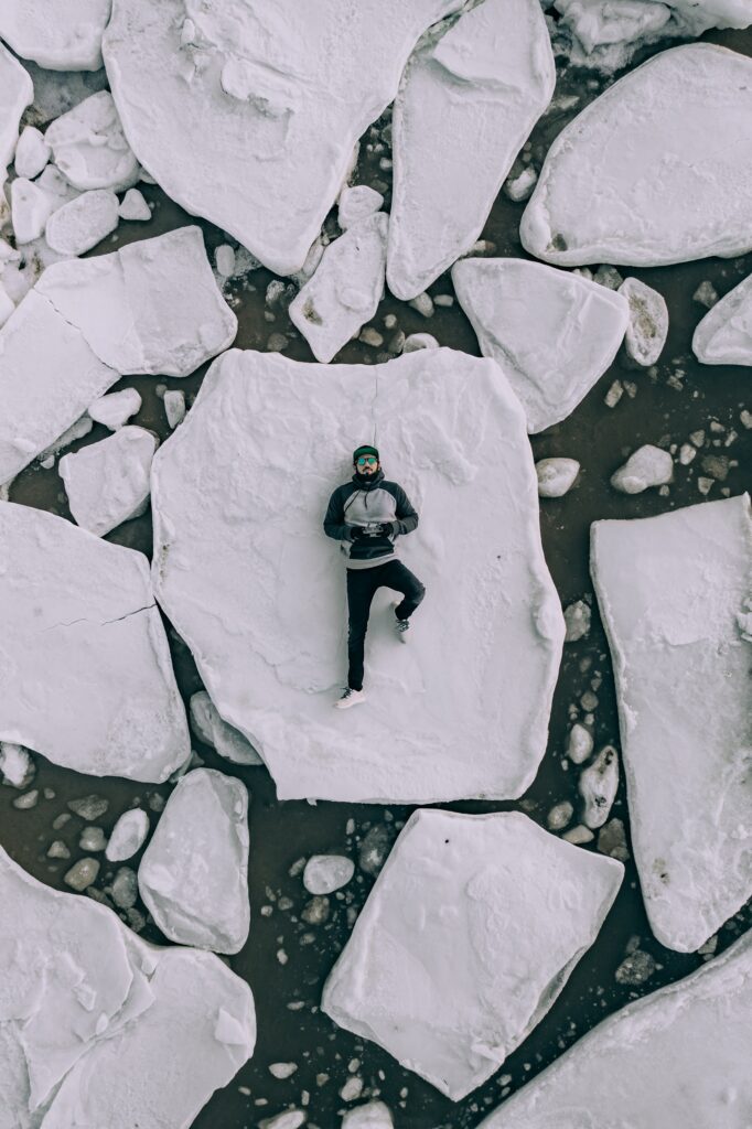 Man lying on his back on broken ice