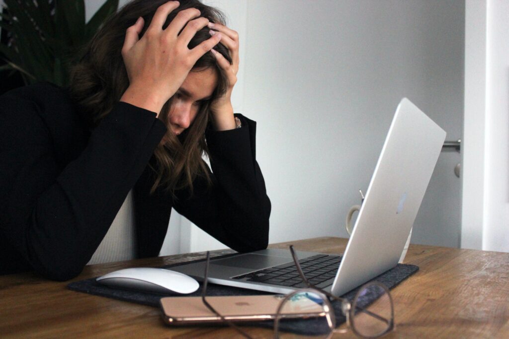 Photo by Elisa Ventur on Unsplash. A woman who is stressed.