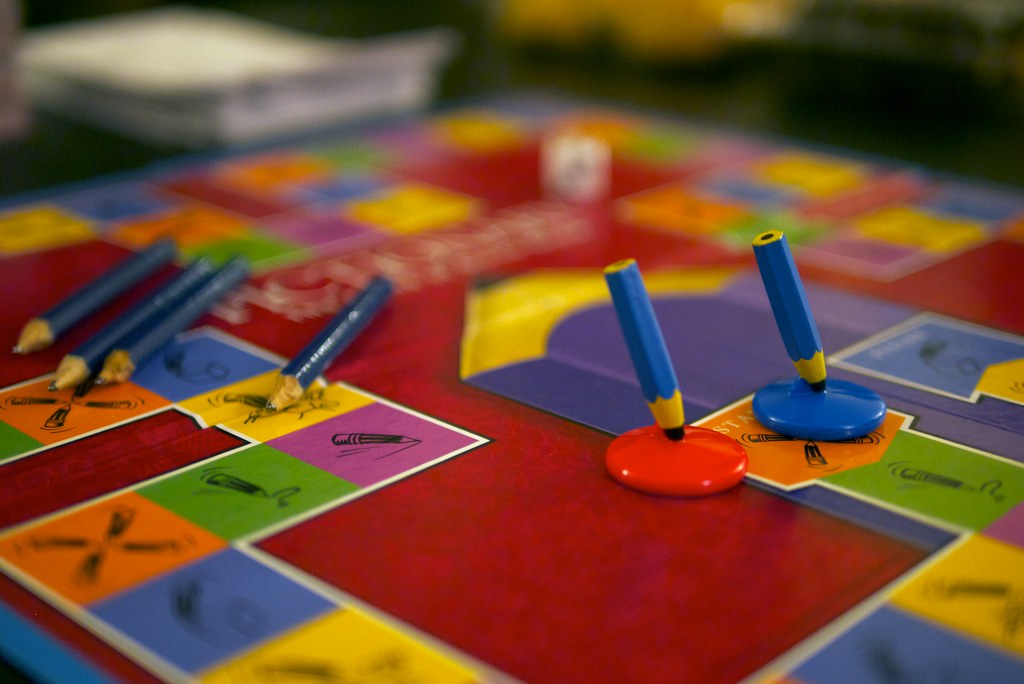 Pictionary board game with pieces and playing spaces