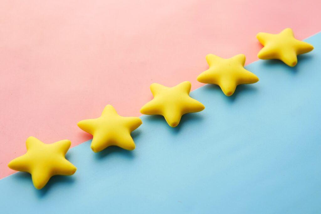 five little yellow stars on a blue and pink background.
