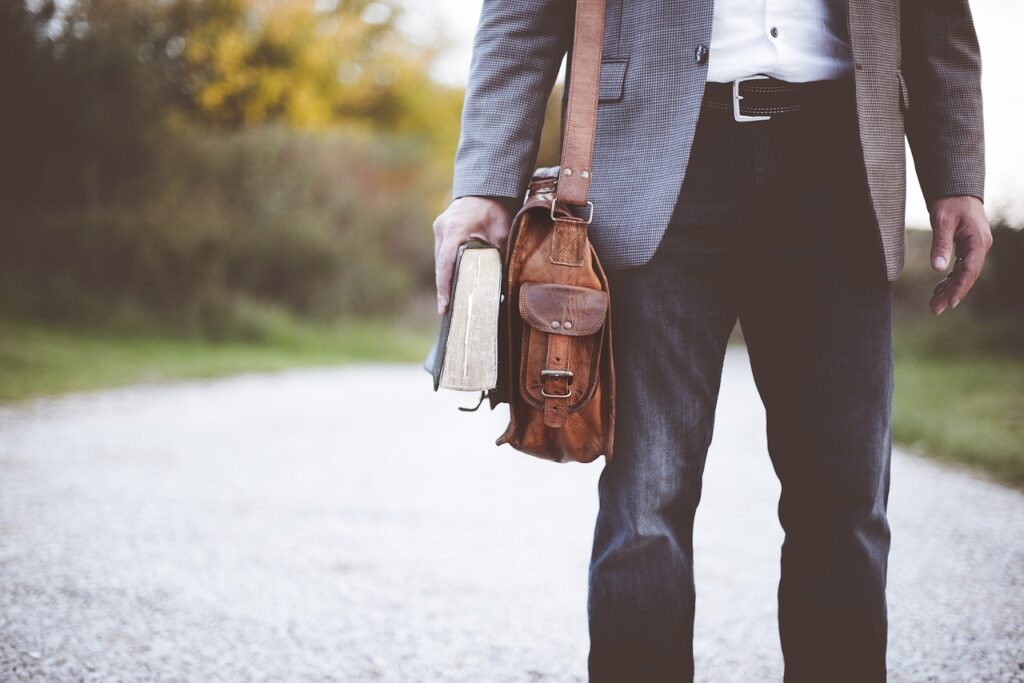 Holding a book and back with road in background