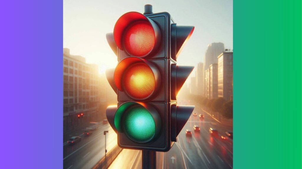 A traffic light with red, orange, and green light