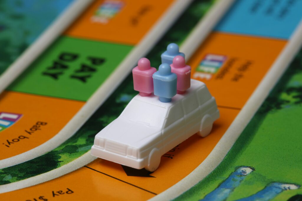 a toy car from the game of life, with people pegs in it. They're going places!