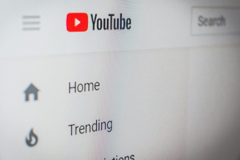 A photo take of a desktop screen with YouTube open on their browser, showing only the Home, Trending, and part of the empty search bar.